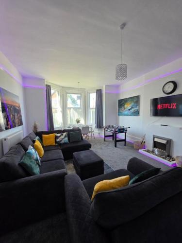 a living room with two couches and a fireplace at Spacious - 8ight Havens Folkestone in Folkestone
