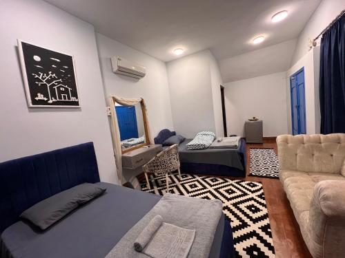 a living room with a couch and a bed and a chair at iBiZa Hostel in Beni Suef