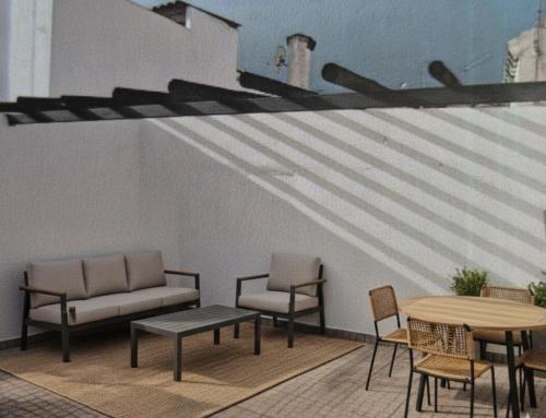 a patio with chairs and a table and a bench at Casa Branco in Borba