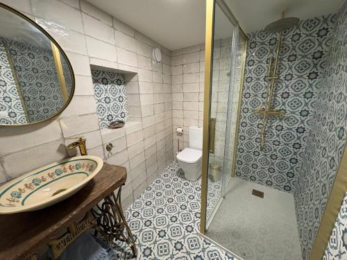 a bathroom with a sink and a shower at CASINA La RIBERA in Cudillero