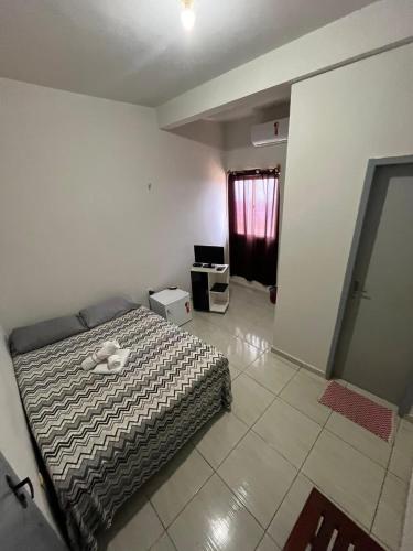 a bedroom with a bed in a room at Pousada e Hostel Santos in Barreirinhas