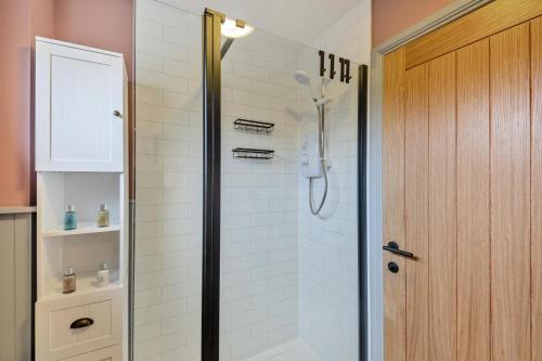 a shower with a glass door in a bathroom at 2 Bed in Lowick oc-c34008 in Lowick