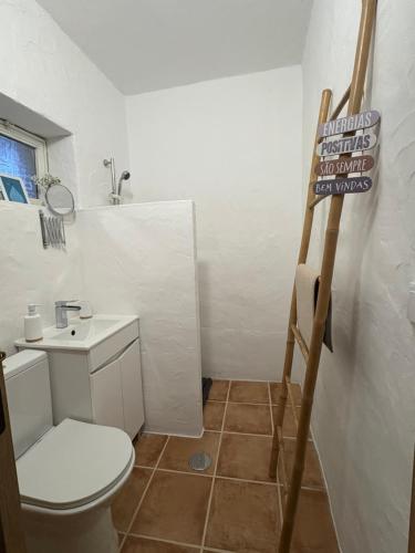 a small bathroom with a toilet and a sink at Canto da Planície in Conceição