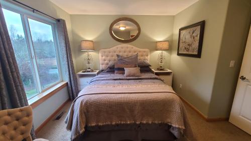 a bedroom with a bed and a large window at Mt Rainier Way Bedroom with Private Full Bath in Eatonville