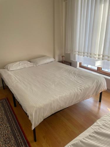 a large bed in a room with a window at Villa Efes in Hisarcık