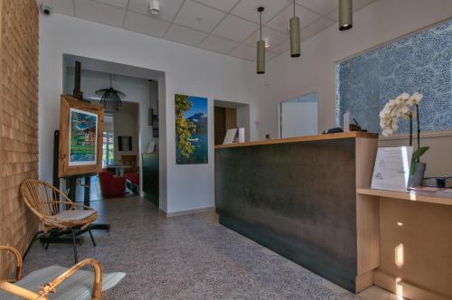 a salon with a reception desk and a chair at Hôtel Beau Site Talloires B SPA in Talloires