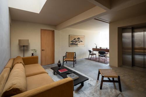 a living room with a couch and a table at Hotel Oculto in Mexico City