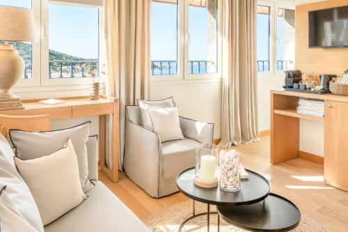 a living room with a couch and a table at Boutique hôtel Château Rouher in Propriano