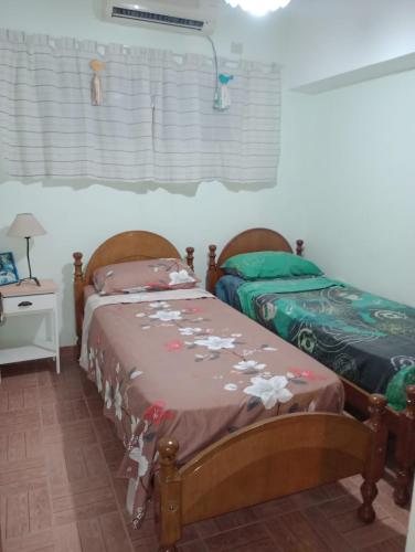 two twin beds in a room with a window at San Juan Santo Tome in Santo Tomé