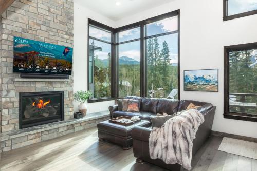 a living room with a couch and a fireplace at Evergreen Reserve in Winter Park