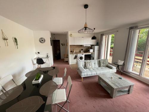 a living room with a couch and a table at Appartement Saint Genis Pouilly Cern in Saint-Genis-Pouilly