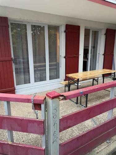 a picnic table on the porch of a house at Appartement Saint Genis Pouilly Cern in Saint-Genis-Pouilly