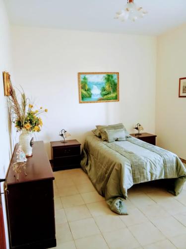 a bedroom with a bed and two night stands and a table at Casa Presenza in Santa Elisabetta