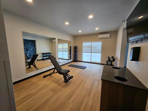 a gym with a chair and a desk in a room at La Quinta Inn & Suites by Wyndham Minot in Minot