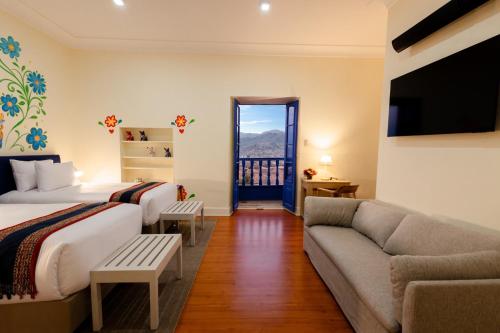 a hotel room with two beds and a couch at 7 Toritos Hotel Boutique by Hacienda in Cusco