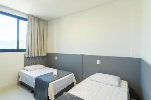 En eller flere senge i et værelse på Aptos em prédio a 90 m da praia de Perequê - RIHs