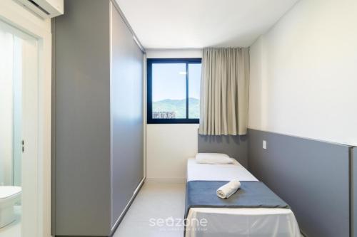 En eller flere senge i et værelse på Aptos em prédio a 90 m da praia de Perequê - RIHs