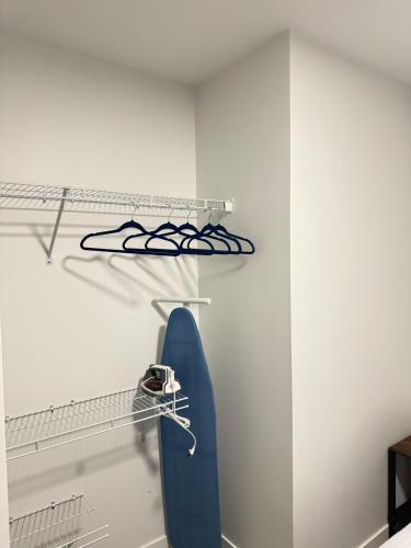 a room with a blue surfboard on a shelf at Cozy 1-Bedroom with Natural lights in Edmonton