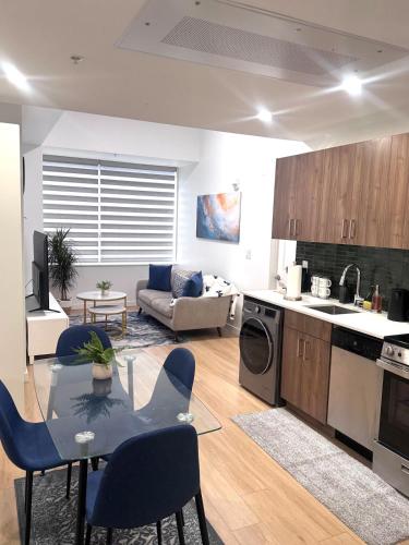 a kitchen and living room with a table and chairs at Cozy 1-Bedroom with Natural lights in Edmonton