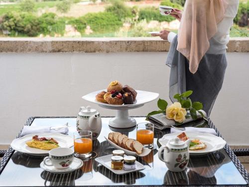 a table with a tray of breakfast food on it at Borgobianco Resort & Spa Polignano - MGallery Collection in Polignano a Mare