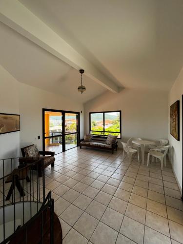 a large living room with a table and chairs at A casa do sonho in Palhoça