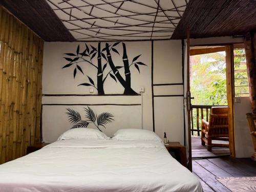 una camera da letto con un letto e un dipinto sul muro di Paradise Camp 