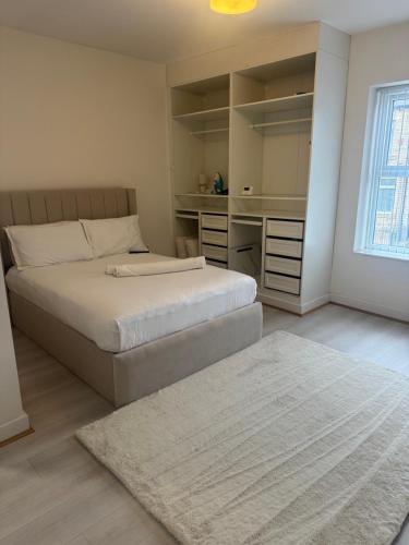a bedroom with two beds and a rug at The Beige House in Batley