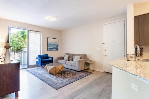 a living room with a couch and a table at Spacious 3BR | Pool, Gym, Near Beach & Speedway in Daytona Beach