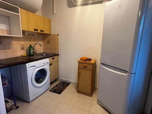 a kitchen with a refrigerator and a washing machine at Cosy studio plages Antibes in Antibes