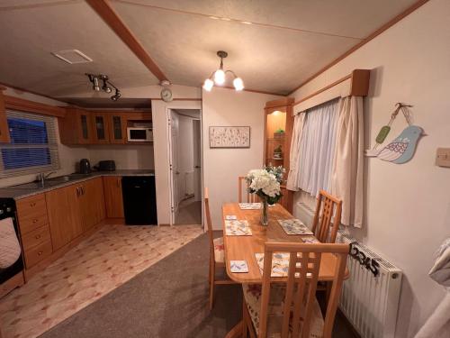 a kitchen and dining room with a table and chairs at A and C Coastal Hideaway Private Decking in Colchester