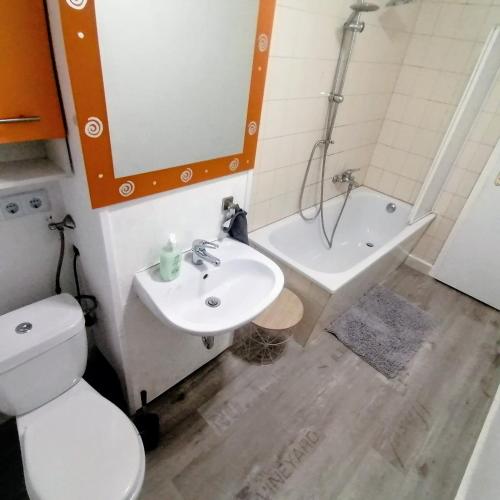 a bathroom with a toilet and a sink and a tub at Ferienwohnung Lindena - Lausitz in Doberlug-Kirchhain
