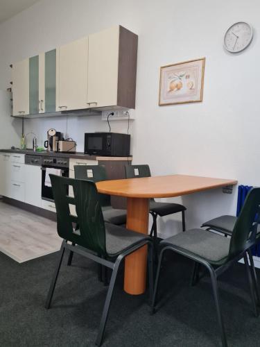 a table and chairs in a room with a kitchen at Ausblick Freital 4 in Freital