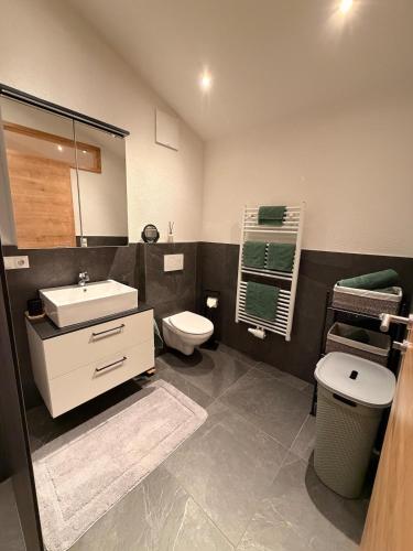 a bathroom with a white sink and a toilet at Haus Antonia in Kauns