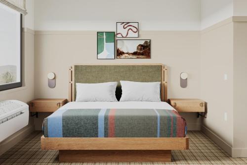 a bedroom with a bed with a striped blanket at Outbound Yosemite in Oakhurst