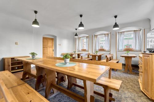 a dining room with wooden tables and benches at Horská chata Silver by Mountain ways in Boží Dar