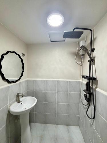 a bathroom with a sink and a mirror at Maison kh in Suba