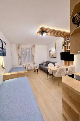 a living room with a couch and a table at Konaci Prime Center in Kopaonik