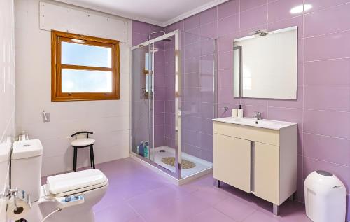 a purple bathroom with a toilet and a sink at Finca Aquí Me Quedo in Murcia