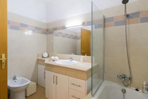 a bathroom with a sink and a toilet and a shower at Brava Home - Best Location to Explore Madeira in Ribeira Brava