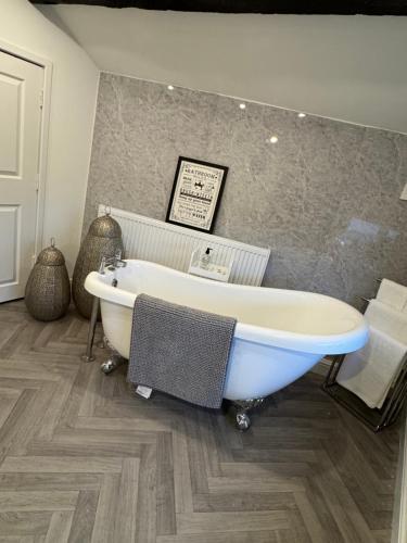 a bath tub in a bathroom with a tile floor at Church view in Conisbrough