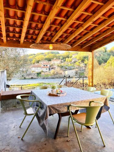 a table and chairs on a patio with a view at Casa Do Guarda Rios in Ponte Nova