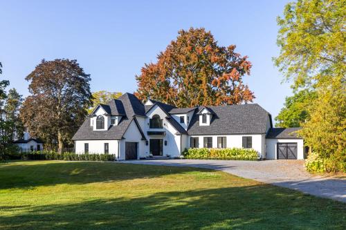 a large white house with a gambrel roof at Vineyard Estate by the River with Pool in Niagara-on-the-Lake