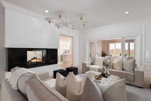 a living room with a couch and a fireplace at Vineyard Estate by the River with Pool in Niagara-on-the-Lake