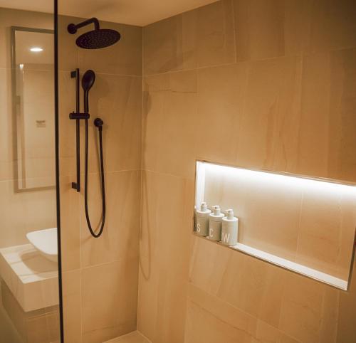 a bathroom with a shower and a sink at Seven @Aquarius in Cairns