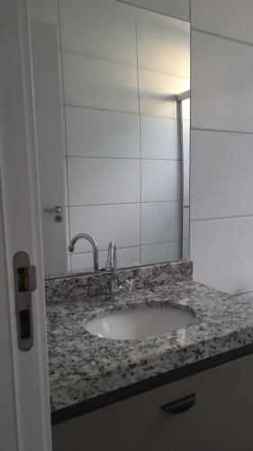 a bathroom counter with a sink and a mirror at Céu da Mantiqueira - Staffy House Extrema in Extrema