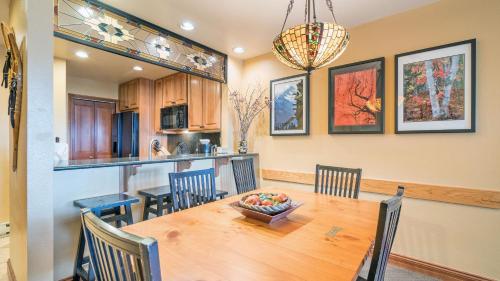 a kitchen and dining room with a wooden table and chairs at Etta Place Too 103 by AvantStay Close to Town The Slopes In Complex w Communal Pool Hot Tub in Telluride