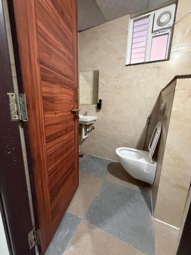 a bathroom with a toilet and a sink at RS Rooftop in Hyderabad