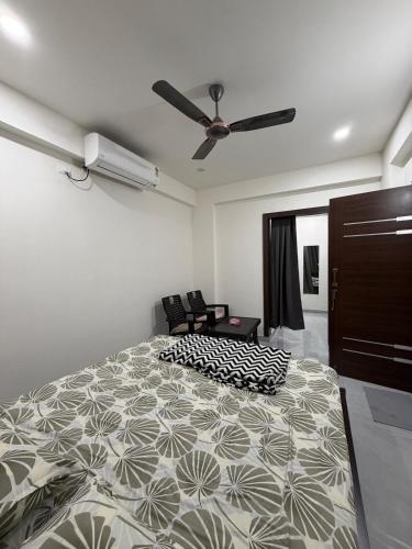 a bedroom with a bed and a ceiling fan at RS Rooftop in Hyderabad