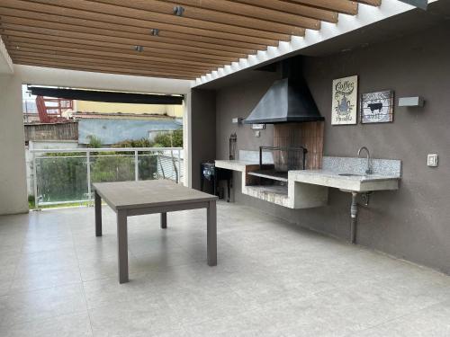 a large kitchen with a table and a sink at Dpto 2 dormitorios vista al mar in Concón