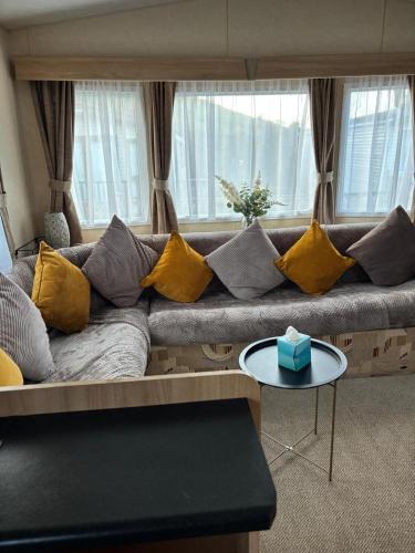 a living room with a couch with yellow pillows at Murphys in Brigham